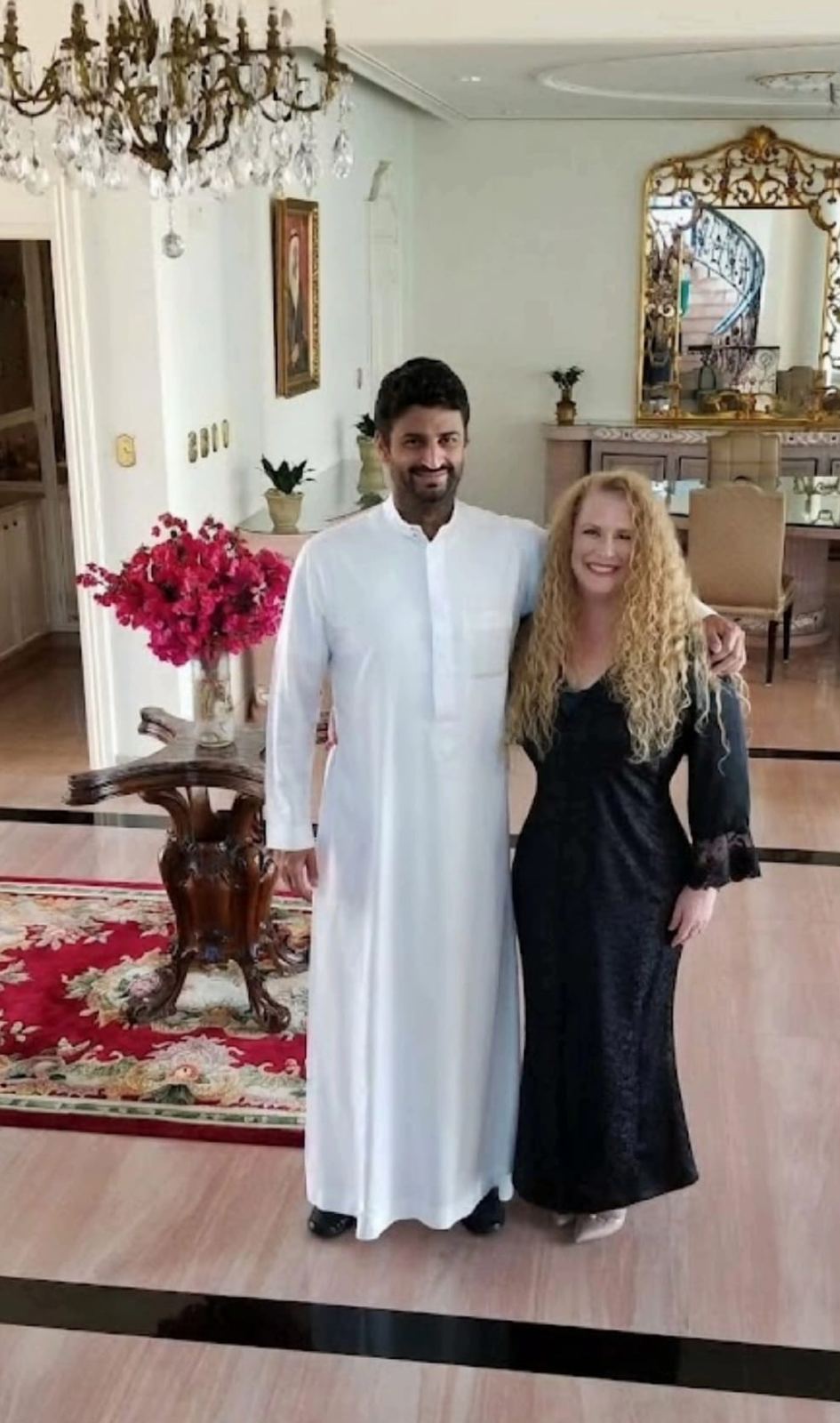 A Guild member with a host in traditional Gulf dress at a private residence