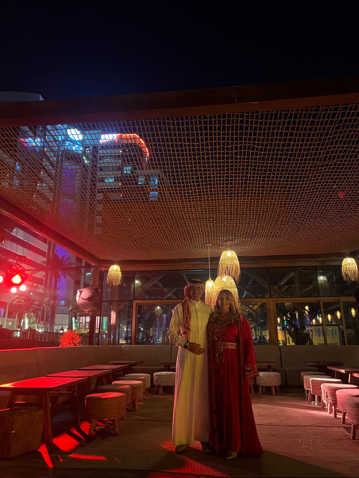Guests in traditional dress on an evening terrace
