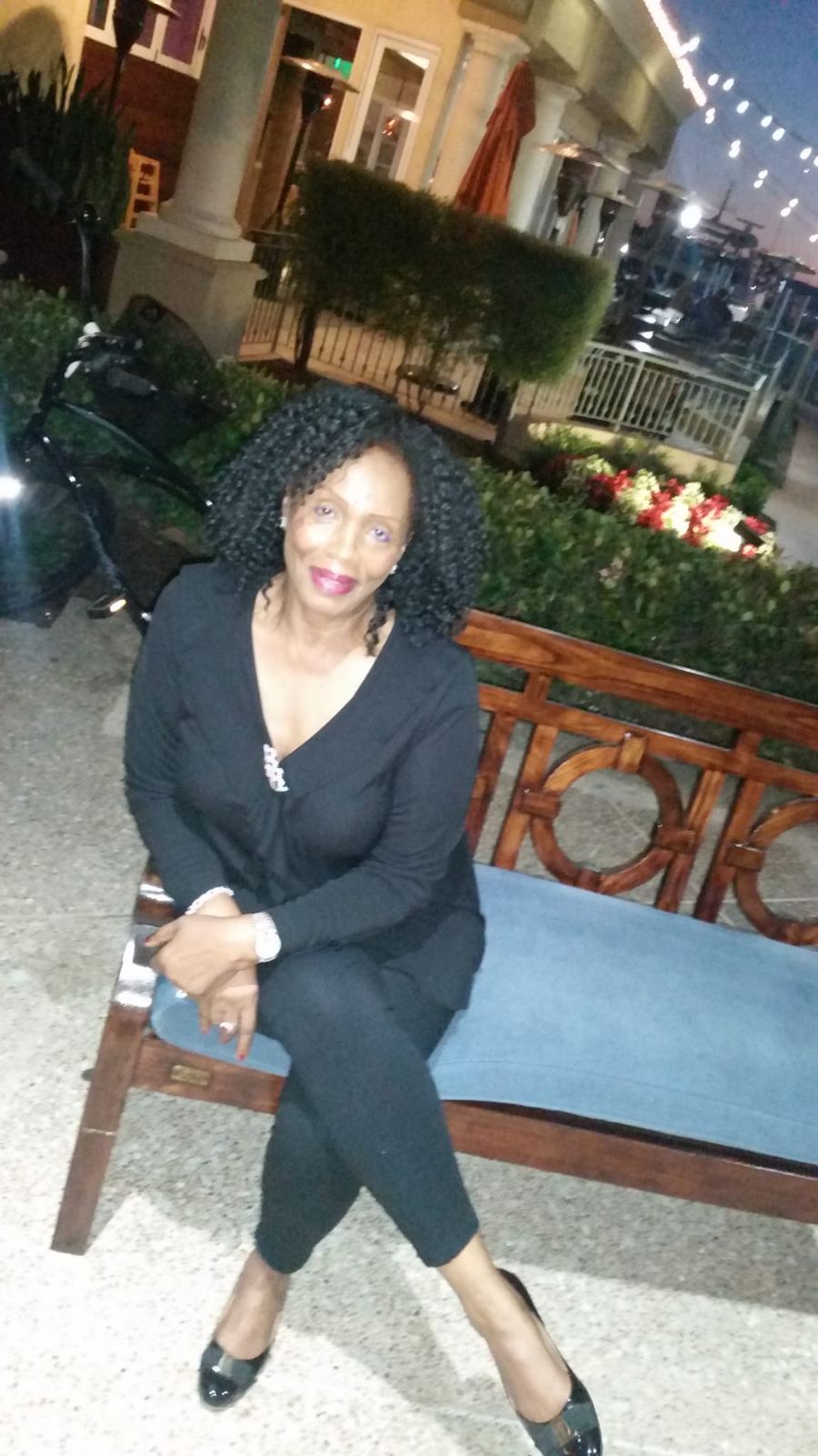 A guest seated on a terrace at dusk