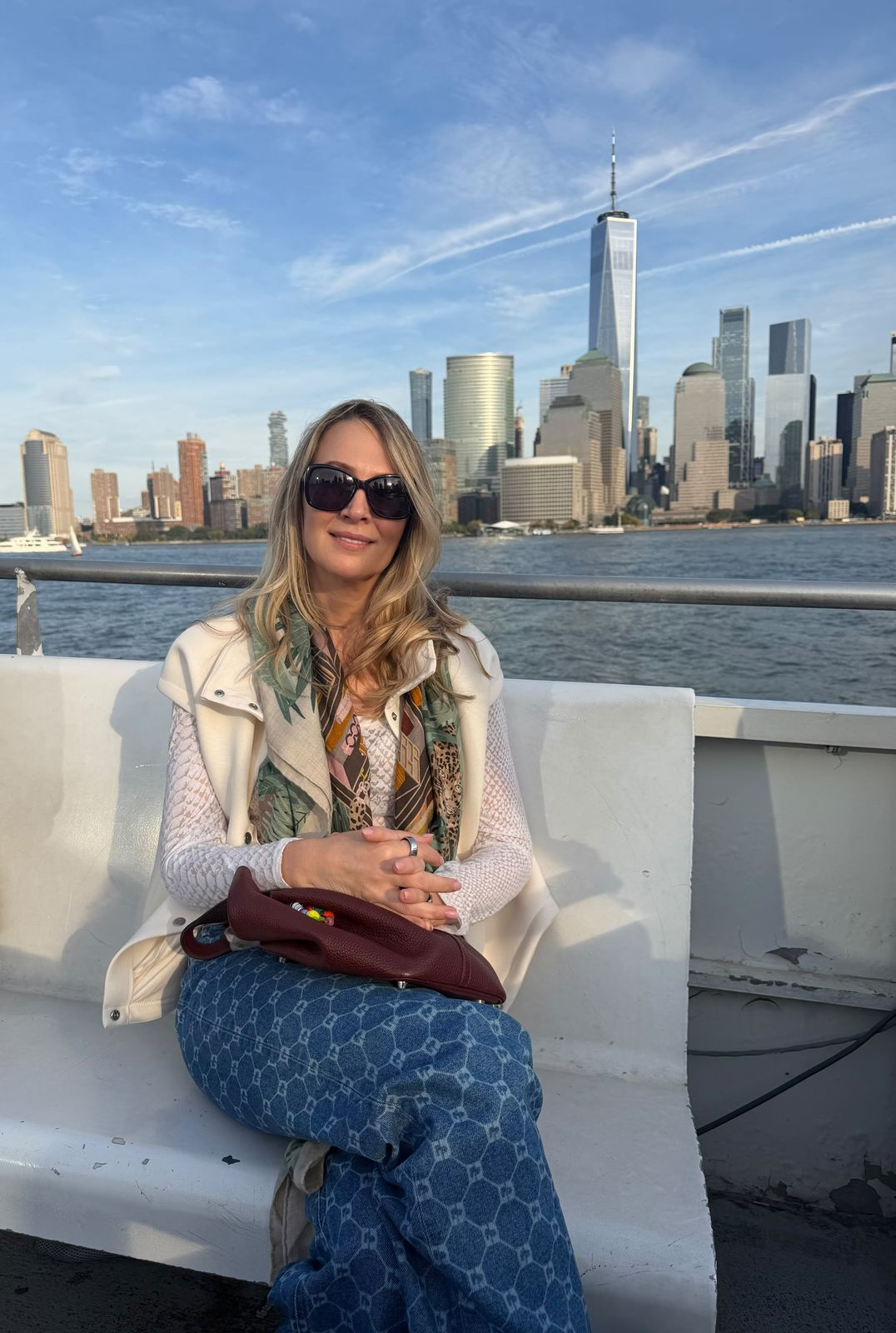 A guest on a ferry with the Manhattan skyline