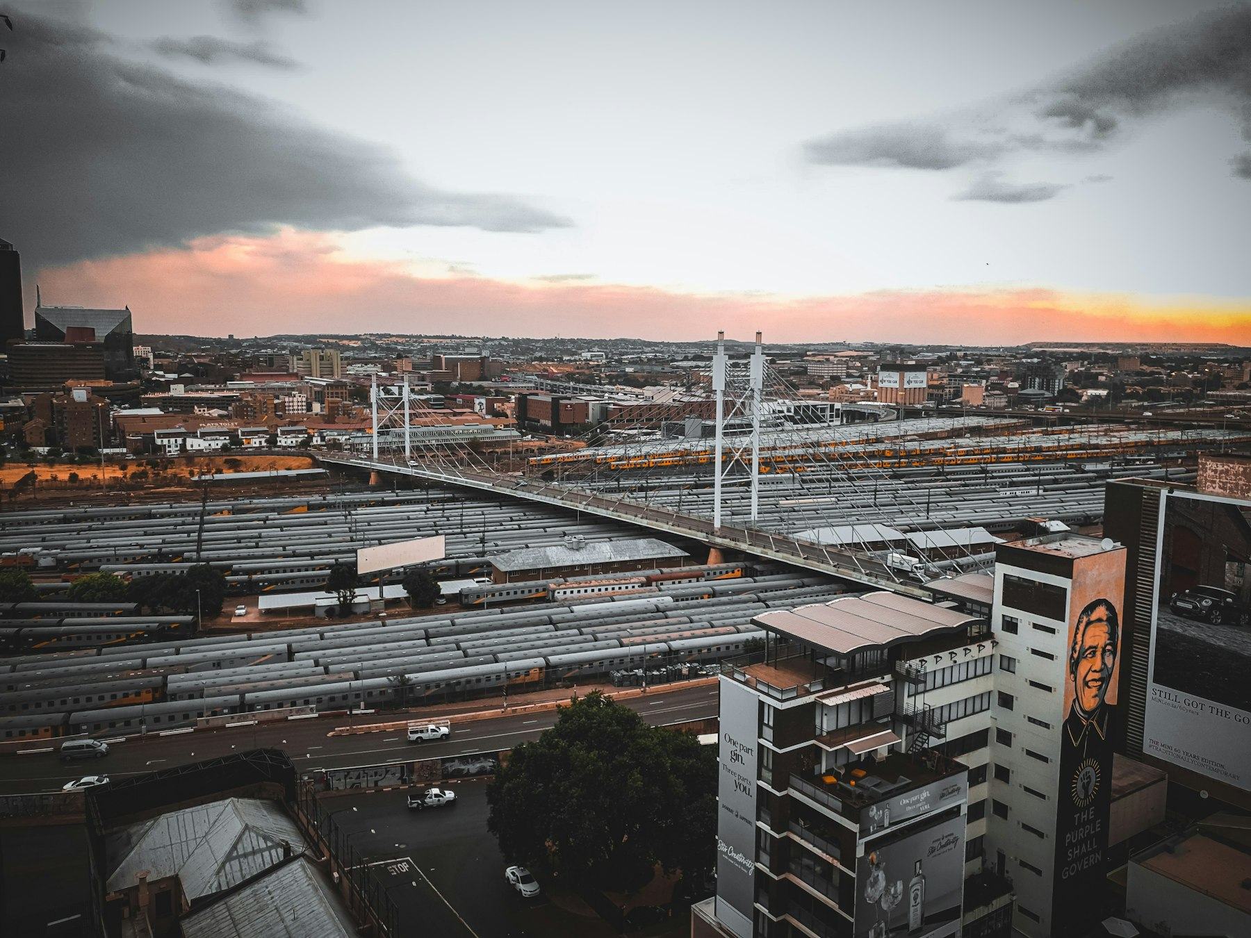 The Nelson Mandela Bridge in Johannesburg beside a mural of Nelson Mandela reading "The People Shall Govern"